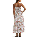 A woman shown from the back wearing a sleeveless white maxi dress with a cowboy-themed print of horses, boots, hats, and horseshoes, paired with brown cowboy boots against a plain white background.
