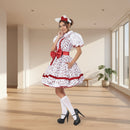 A woman modeling a white and red floral maid costume dress with a matching white hat and red bow, white knee socks, and black high heels against a plain white background.